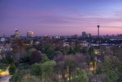 High angle view of city lit up at dusk