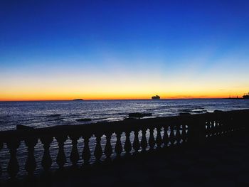 Scenic view of sea against clear sky during sunset