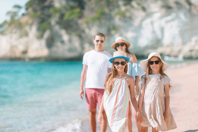 Friends standing on beach