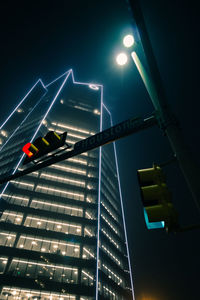 Low angle view of illuminated street light at night