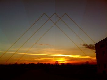 Silhouette of trees against sky at sunset