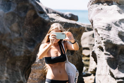 Man photographing on rock