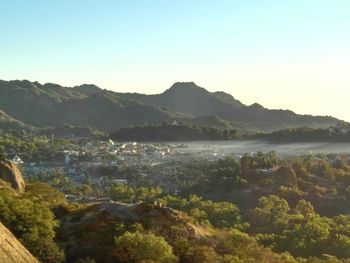 Scenic view of lake and mountains against clear sky