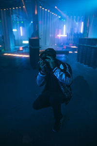 Full length of woman in illuminated city at night