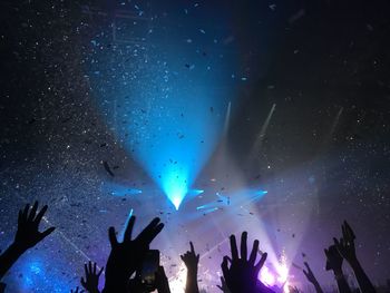 Raised hands at a concert