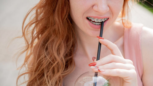 Midsection of woman holding syringe