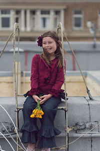 Portrait of smiling young woman holding umbrella