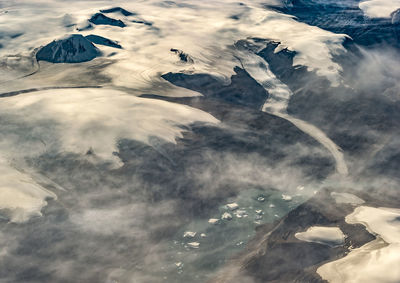 Aerial view of a calving glacier and icebergs