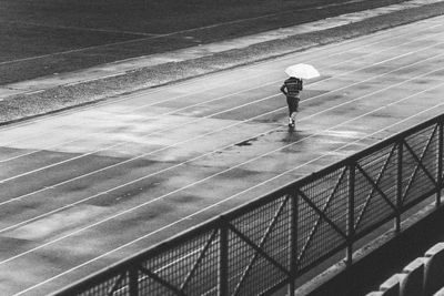 Rear view of woman standing on railing