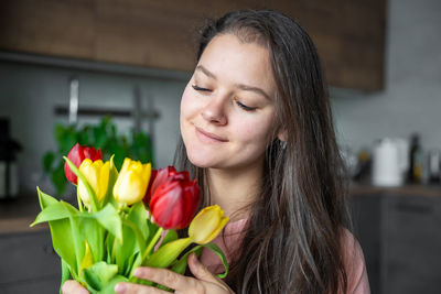 Portrait of young woman with flowers