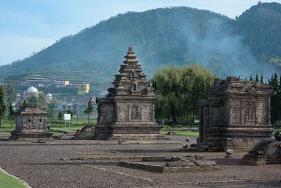 Temple by building against sky