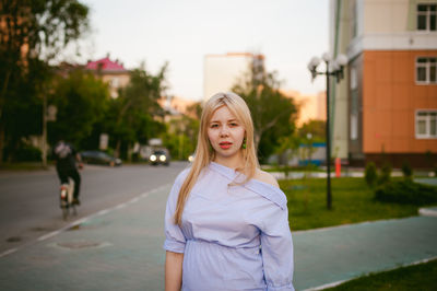 Portrait of woman standing on road