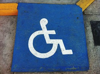 Low angle view of wheelchair sign