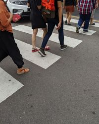 Low section of people walking on road