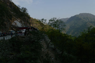 Scenic view of trees and mountains against sky