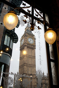 Low angle view of illuminated light bulb hanging