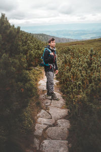 Full length of man standing on path against sky