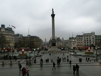 Tourists at town square with city in background