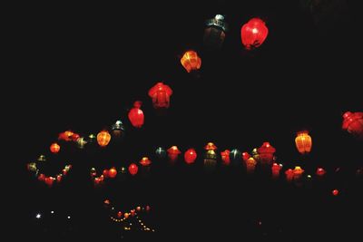 Low angle view of illuminated chinese lanterns hanging at night