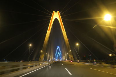 View of illuminated road at night