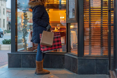 Woman standing by window in store