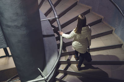 High angle view of woman walking on steps