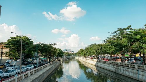 Panoramic view of canal in city against sky