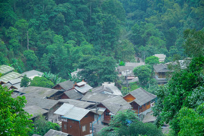 High angle view of houses and trees in forest