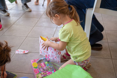 High angle view of women sitting on tiled floor