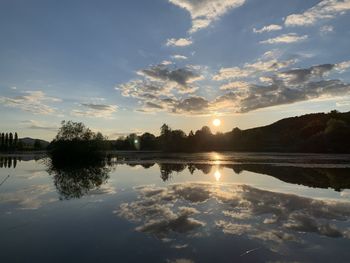 Scenic view of lake against sky during sunset