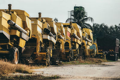 Tractors on field against clear sky