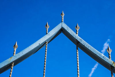 Low angle view of bird against blue sky