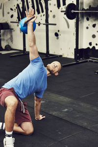 Man training in gym with kettlebell