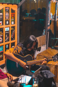 Woman playing guitar