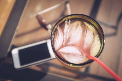 High angle view of drink served on table with smart phone