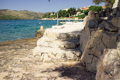 Rocks on beach against sky