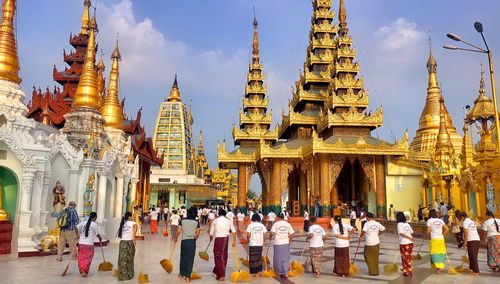 Group of people outside temple against building