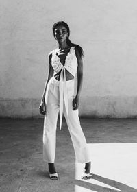 Portrait of young man standing against wall