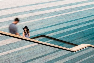 High angle view of people walking on steps by swimming pool