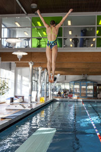 Girl jumping from diving board