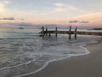 Scenic view of beach against sky during sunset