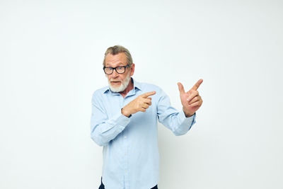 Portrait of man standing against white background