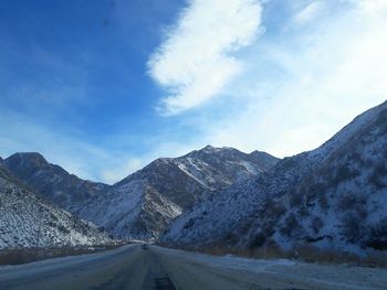 Road amidst mountains against sky