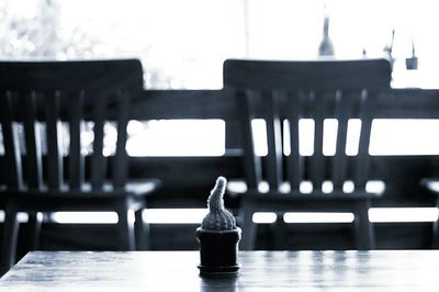 Close-up of chairs on table