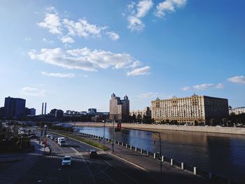 City by river against sky