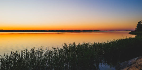 Scenic view of lake against sky during sunset