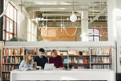 Young people studying in library