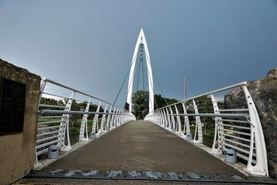 Bridge with tower against clear sky at keeper of the plains site.