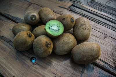 High angle view of kiwi fruits on wooden table