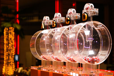 Close-up of illuminated lighting equipment hanging at store